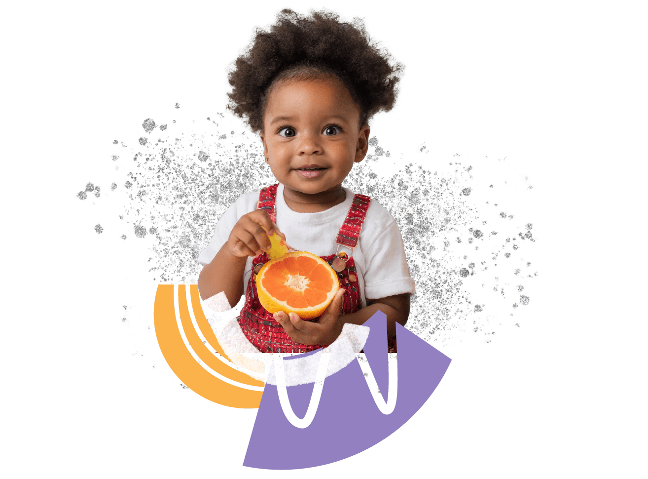 a little girl holding an orange in her hands