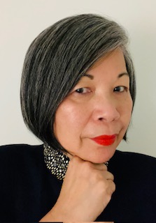 a woman with grey hair and red lipstick