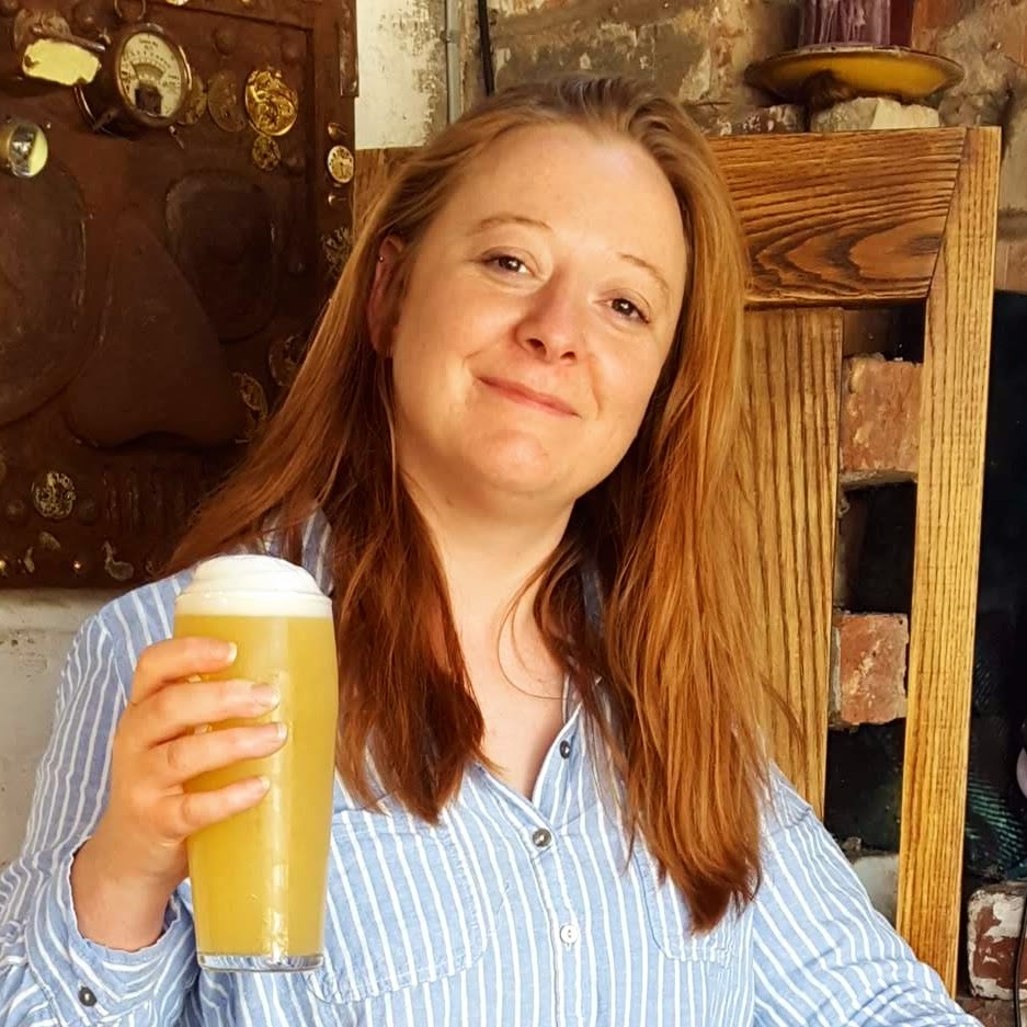 Sarah Hyde holding a glass of beer