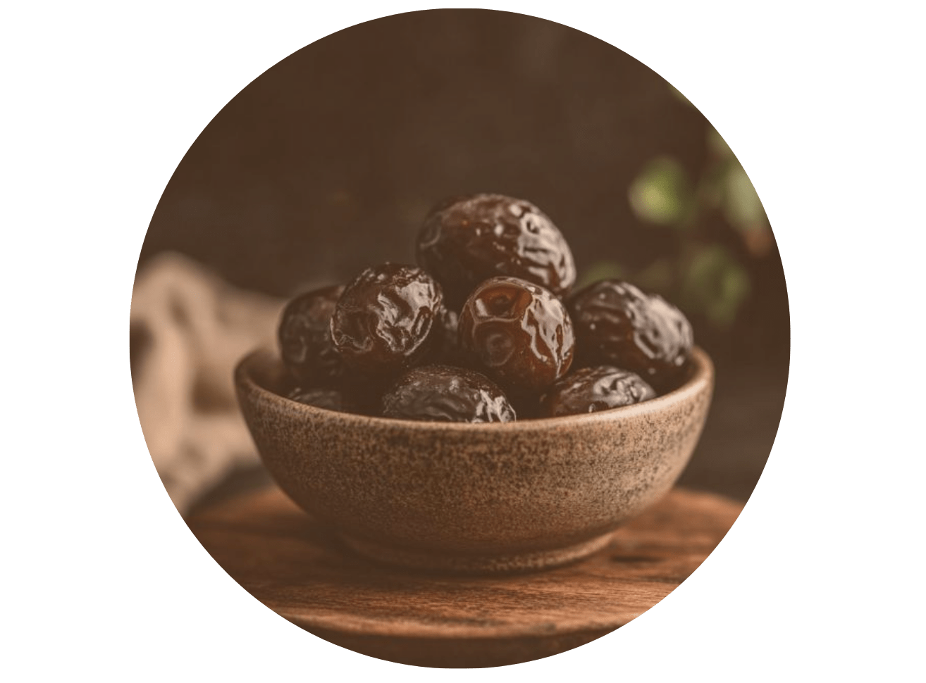 a bowl filled with raisins on top of a wooden table