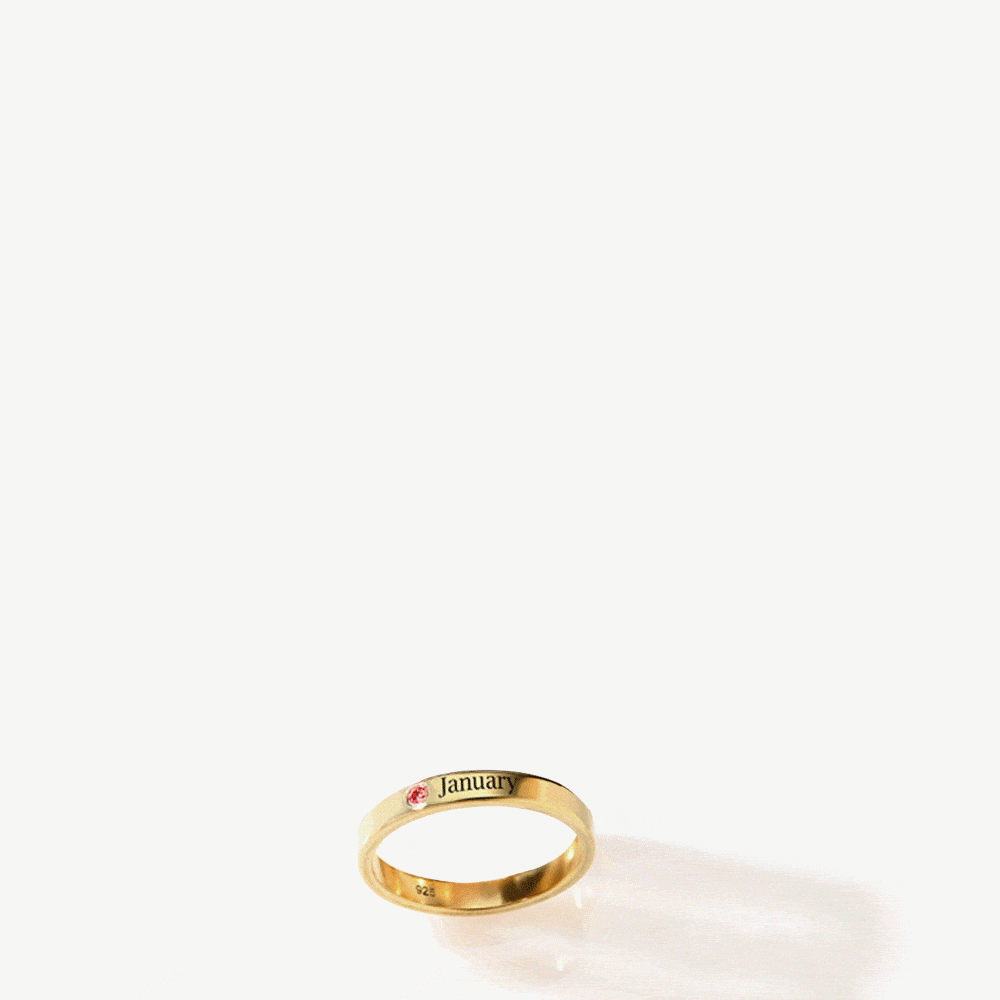 a gold ring with a name engraved on it